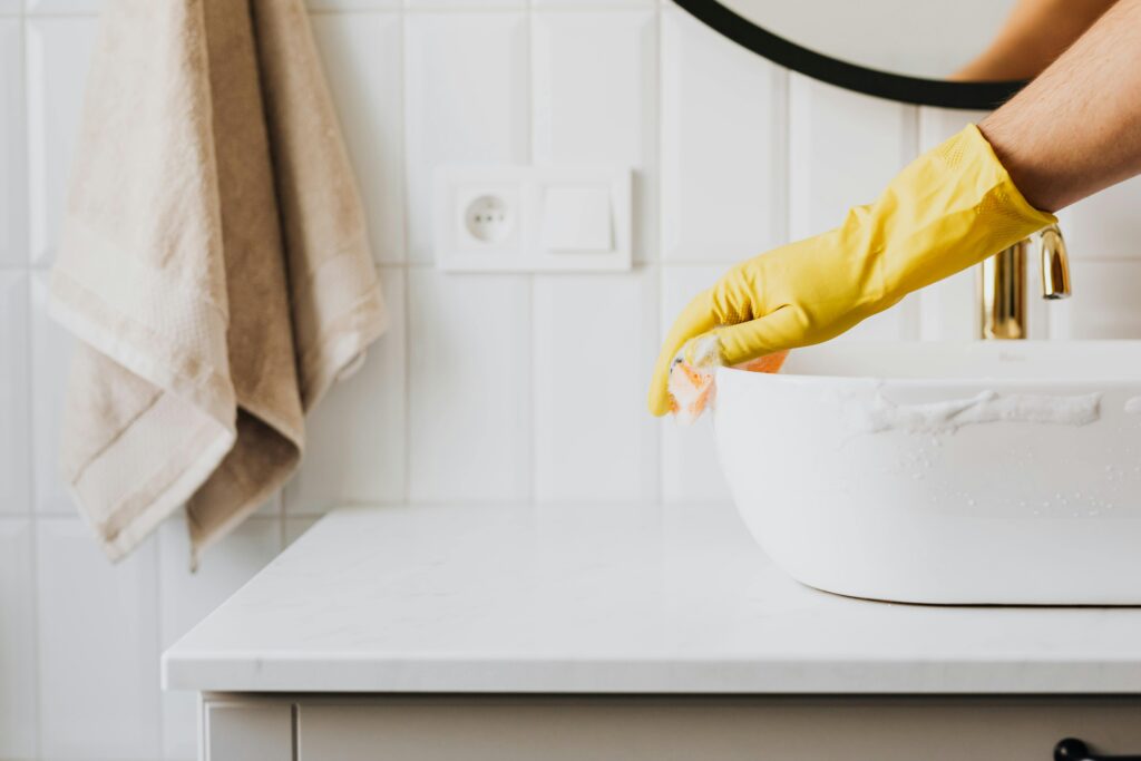 Woman cleaning bathroom sink