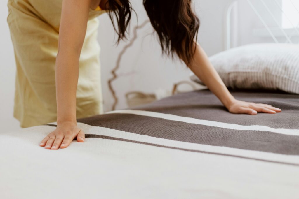 Woman cleaning the bedroom