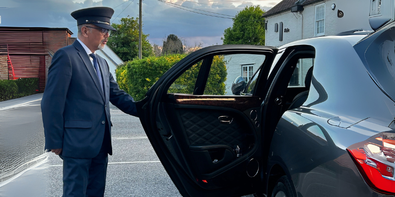 Filipino Chauffeur holding door open domestic support for busy dads