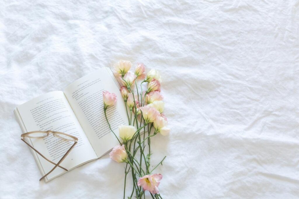 Clean crisp white sheets with flower and book