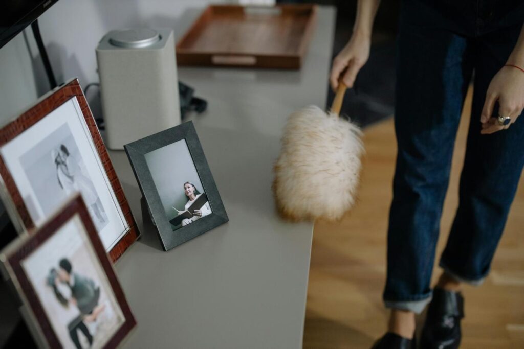 Housekeeper UK dusting off table