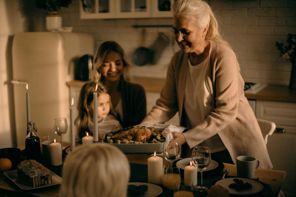 a nanny serving home cooked meals to family