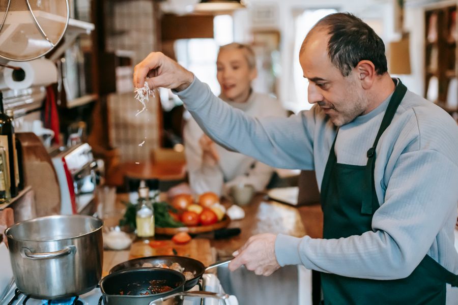 Household cooks cooking together, focusing on homemade cuisine with fresh ingredients